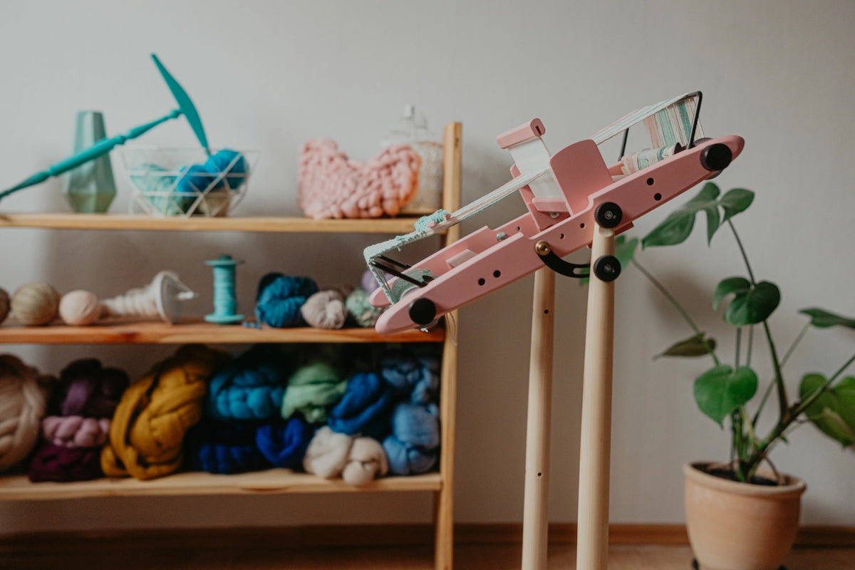 Pink Kromski Presto rigid heddle loom on a stand